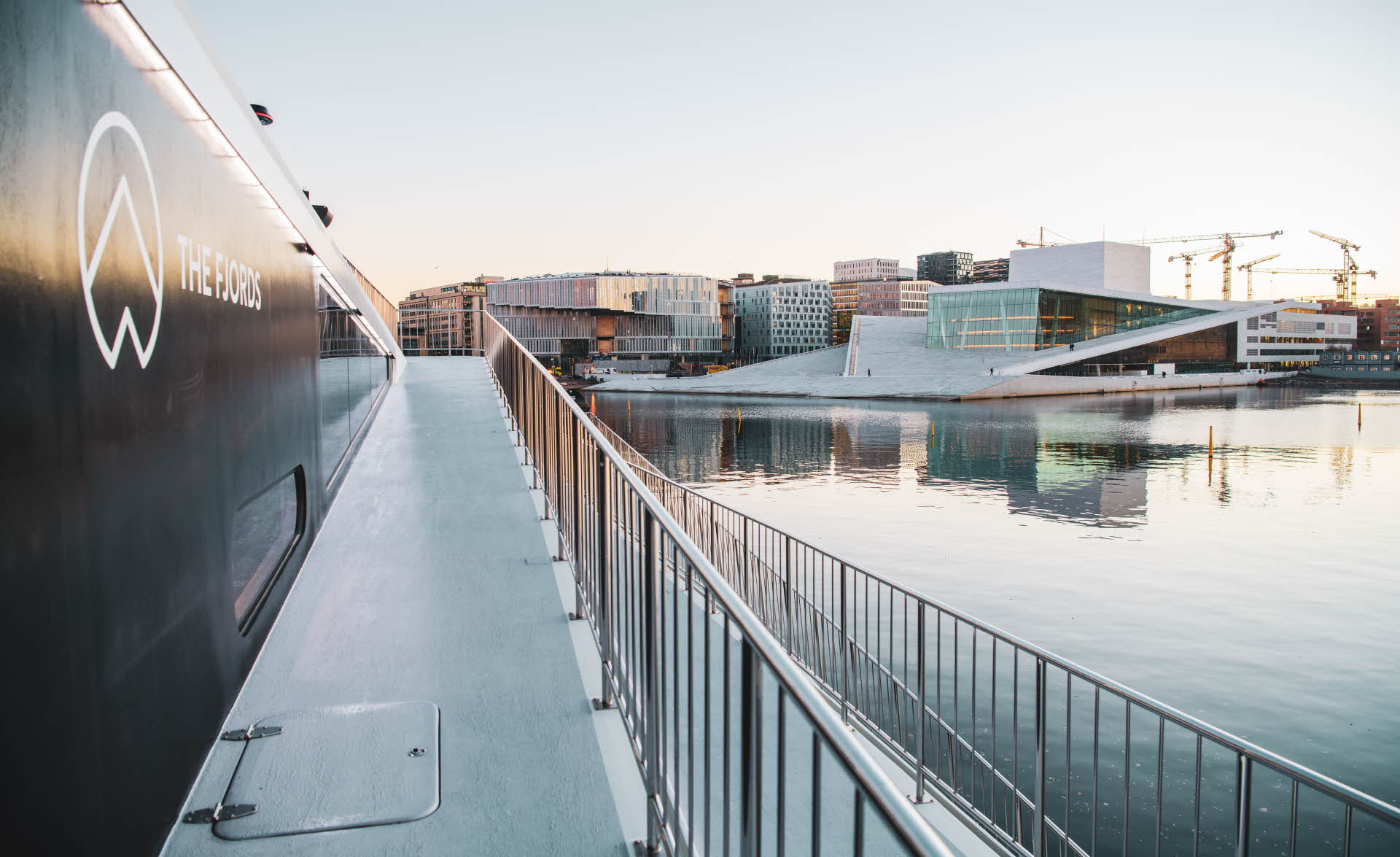 Viewing the Oslo opera house from deck on board The Fjords vessel as sunrise