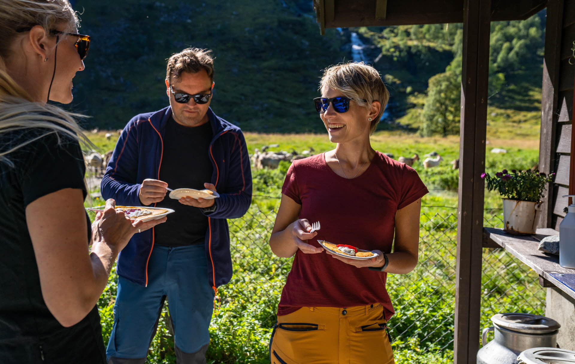 Dos mujeres y un hombre comen tortitas en Rallarrosa Stølssysteri, en el valle de Flåm.