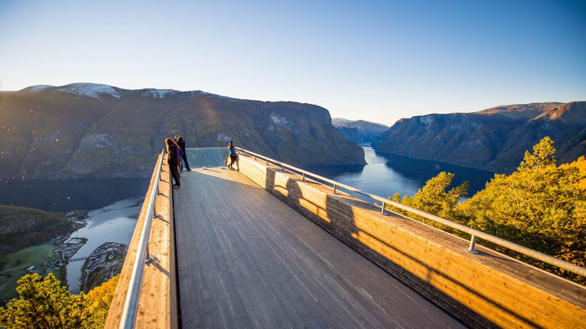 People at the Stegastein Viewpoint above Aurland and the fjord at sunset