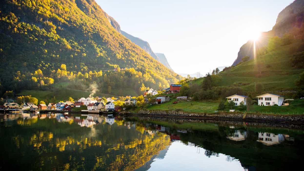 Undredal with its old wooden houses and two newer houses at the edge of the fjord