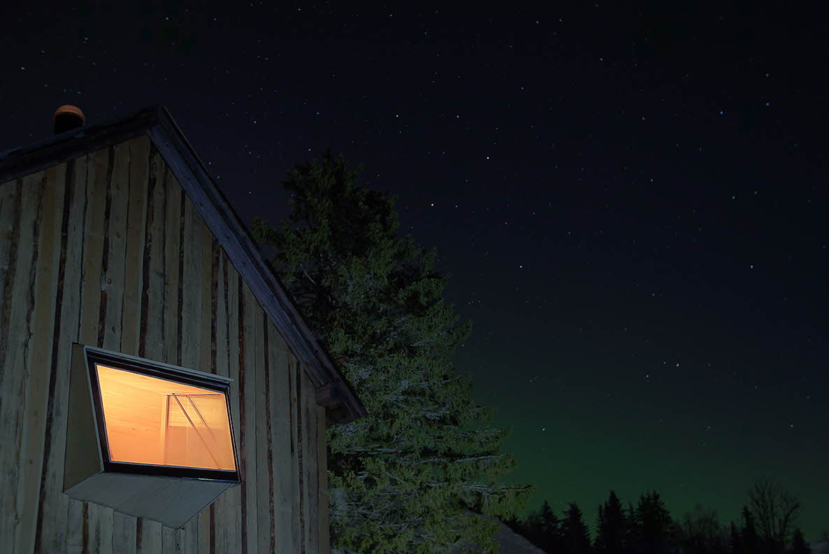 A window in Tråfjosen in Myrkdalen shines out on a clear evening