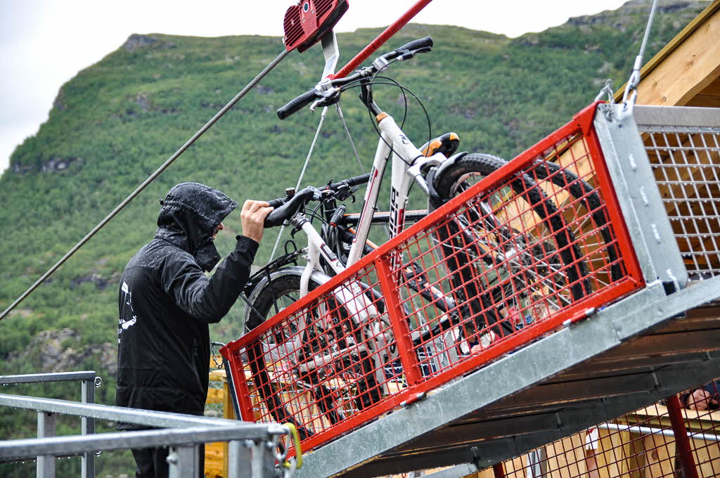 Bikes being loaded into cages at the Flåm Zipline on a rainy day