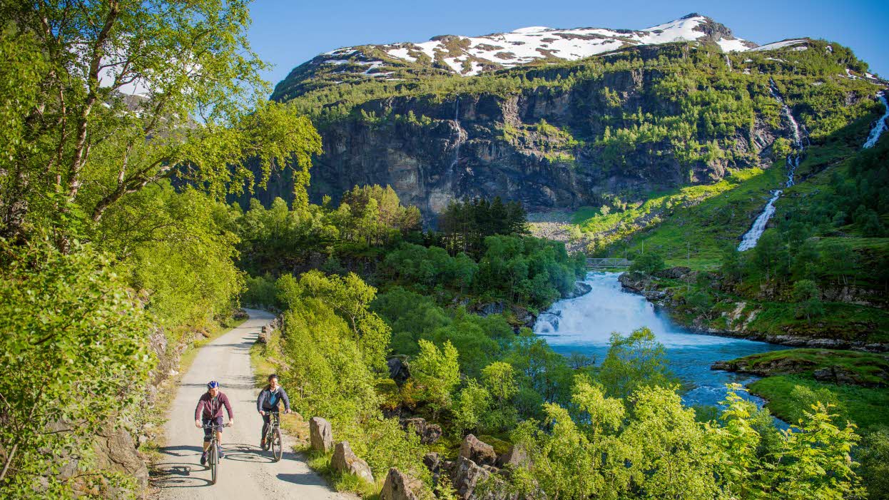 Zwei Radfahrer an einem Fluss auf dem Rallarvegen im Flåmsdalen