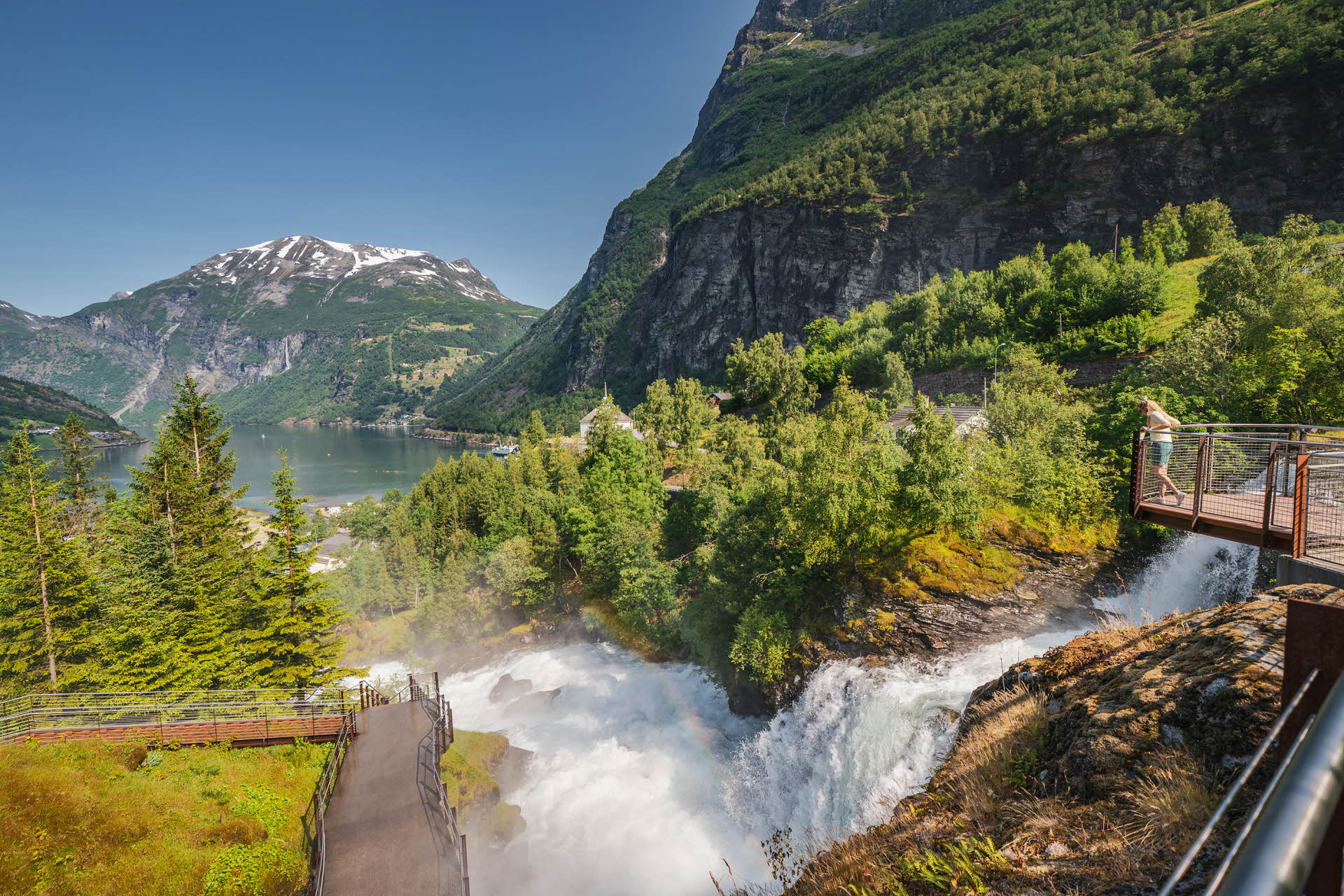 A person standing on the Waterfall trail in Geiranger