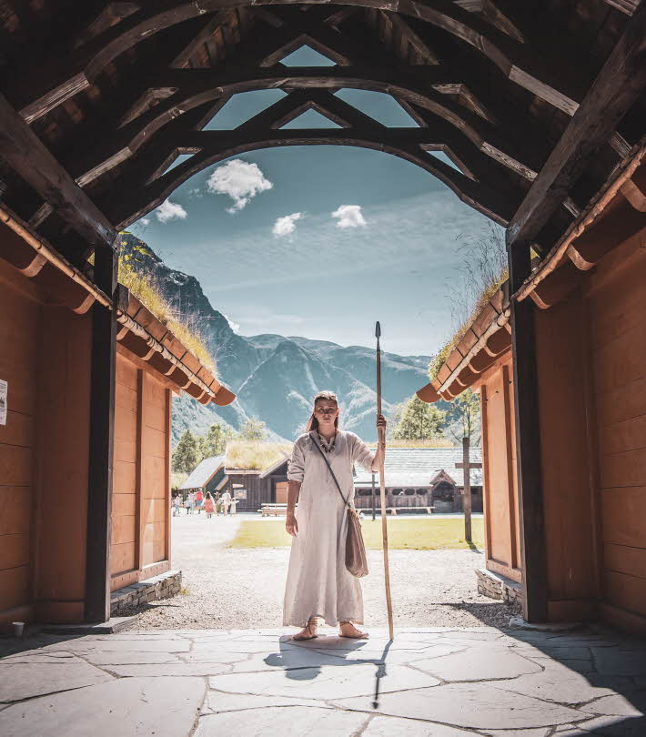 A Viking woman standing in the entrance to the Viking village in Gudvangen