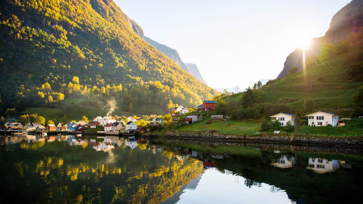 Undredal with its old wooden houses and two newer houses at the edge of the fjord