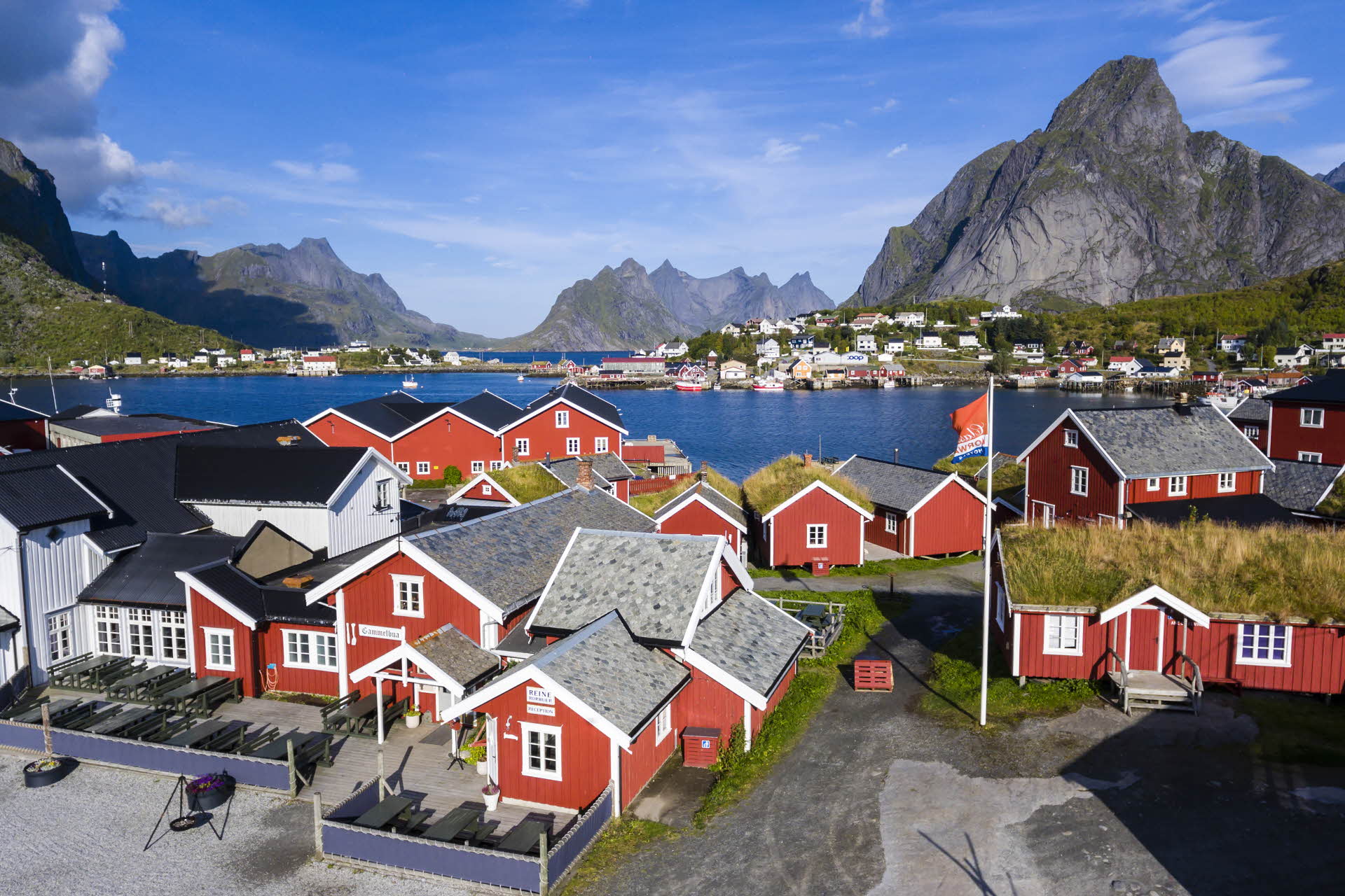 View of Reine on the Lofoten Islands in the summer. Red fisherman's cabins in the foreground, mountains in the background. 