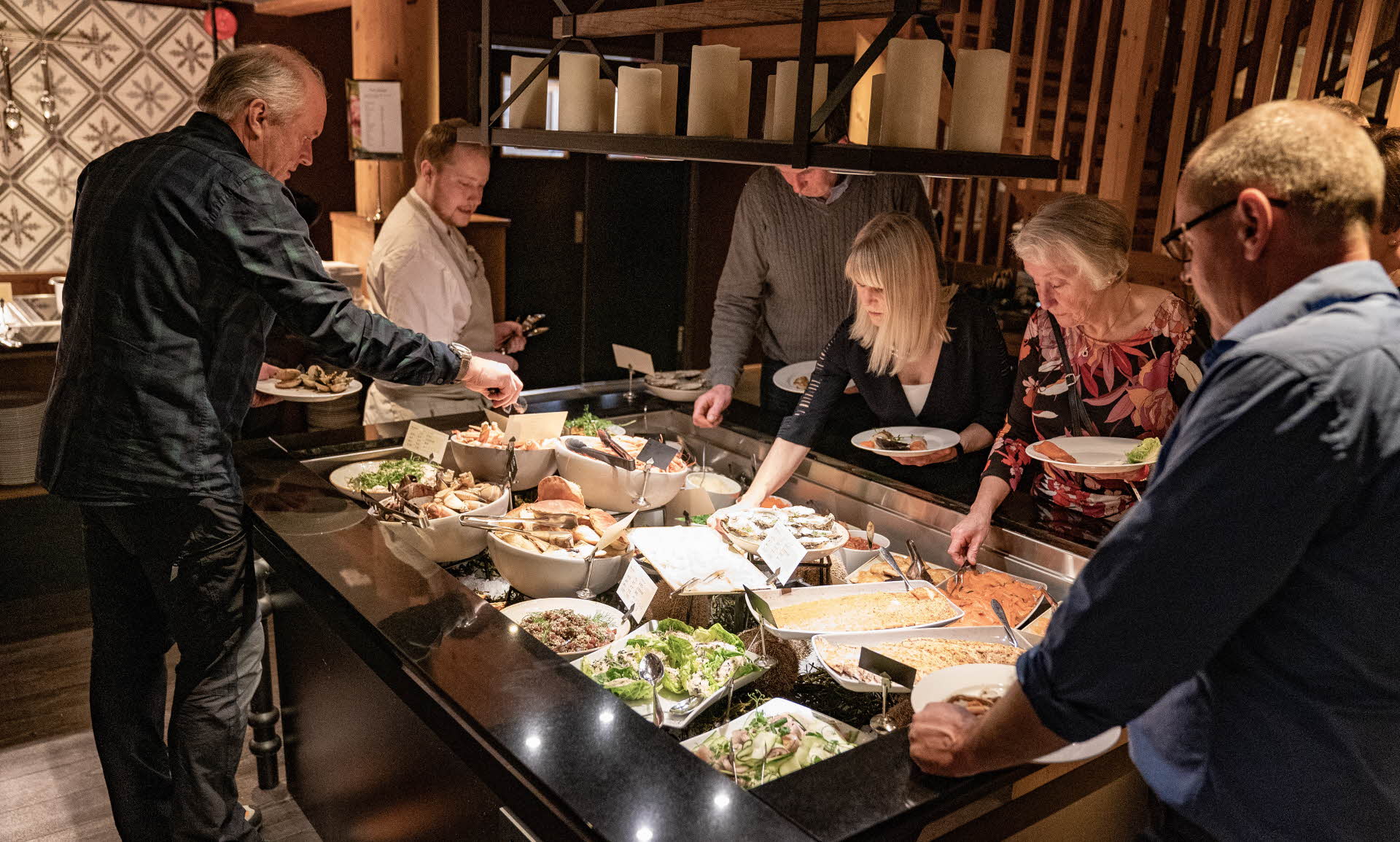 Hotel guests serving themselves from a buffet at Fretheim Hotel in Flåm