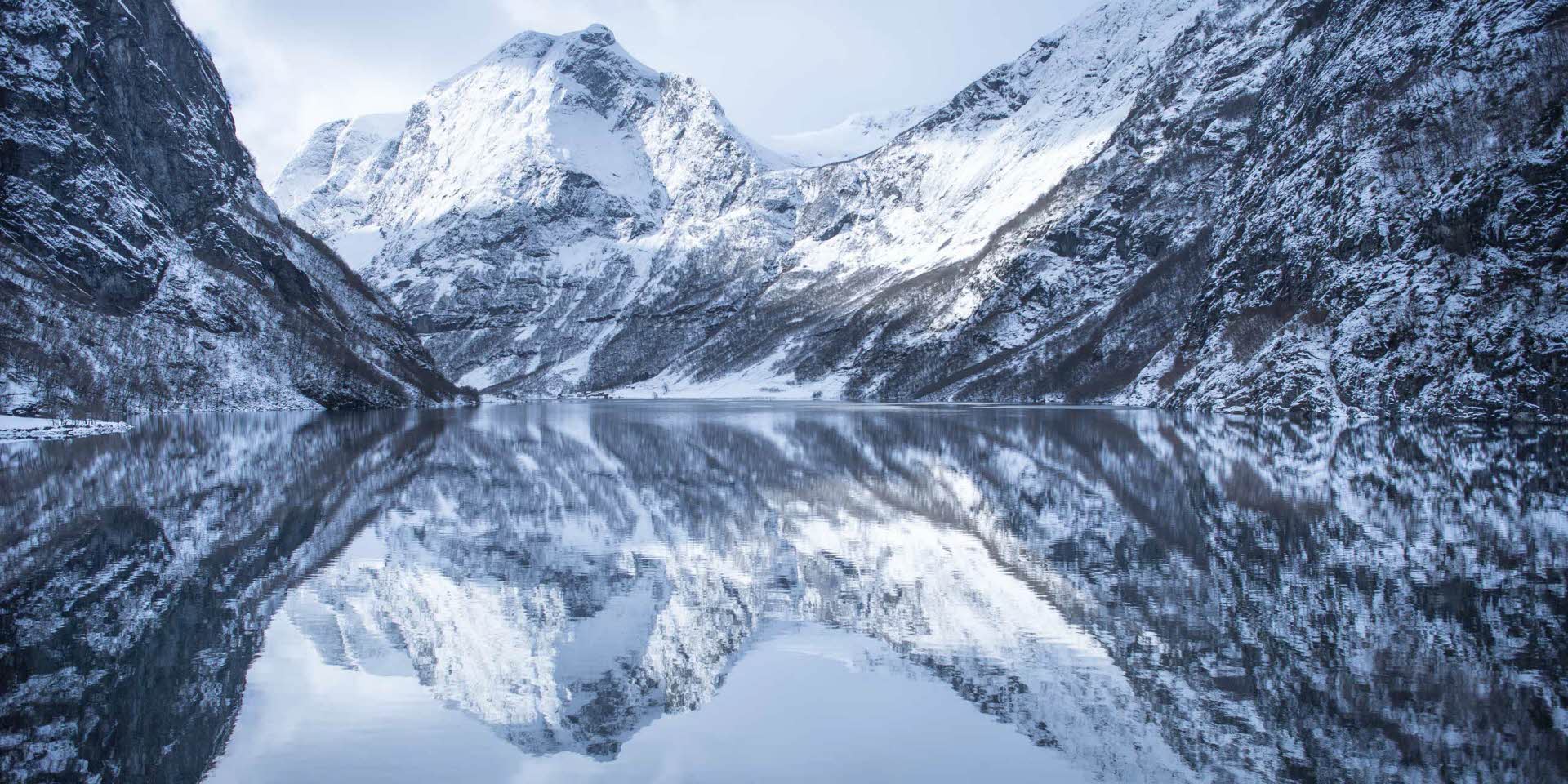 Nærøyfjord in winter with snow clad peaks and still fjord