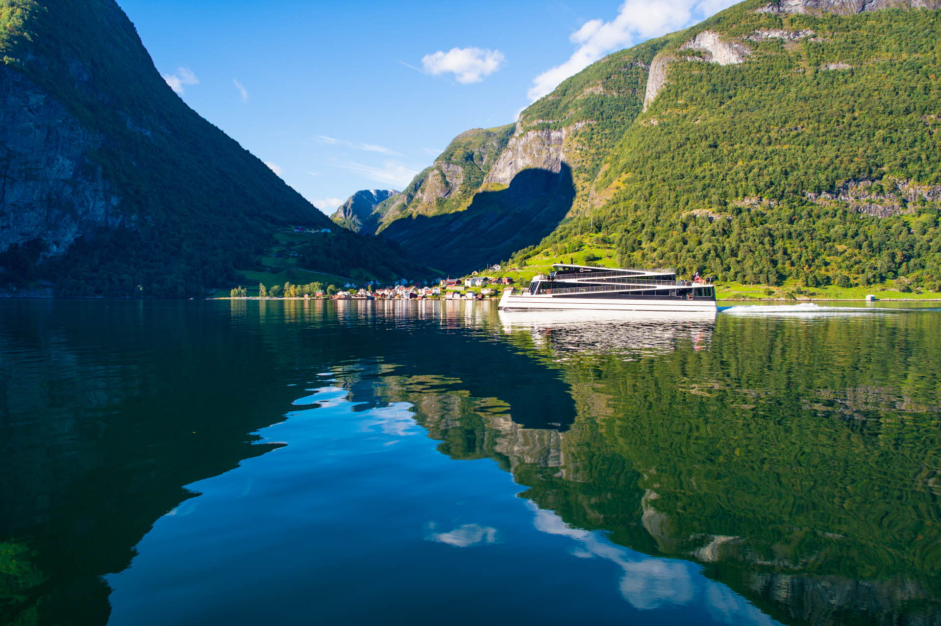 An electric boat passing Undredal in the Aurlandsfjord
