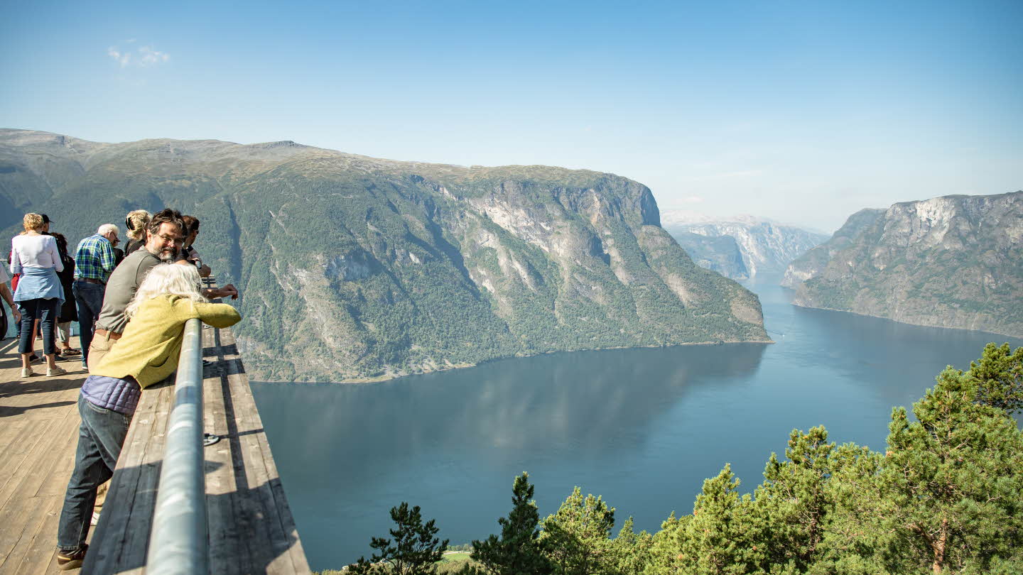 Tourists on Stegastein viewpoint above Aurlandsfjord in summer.