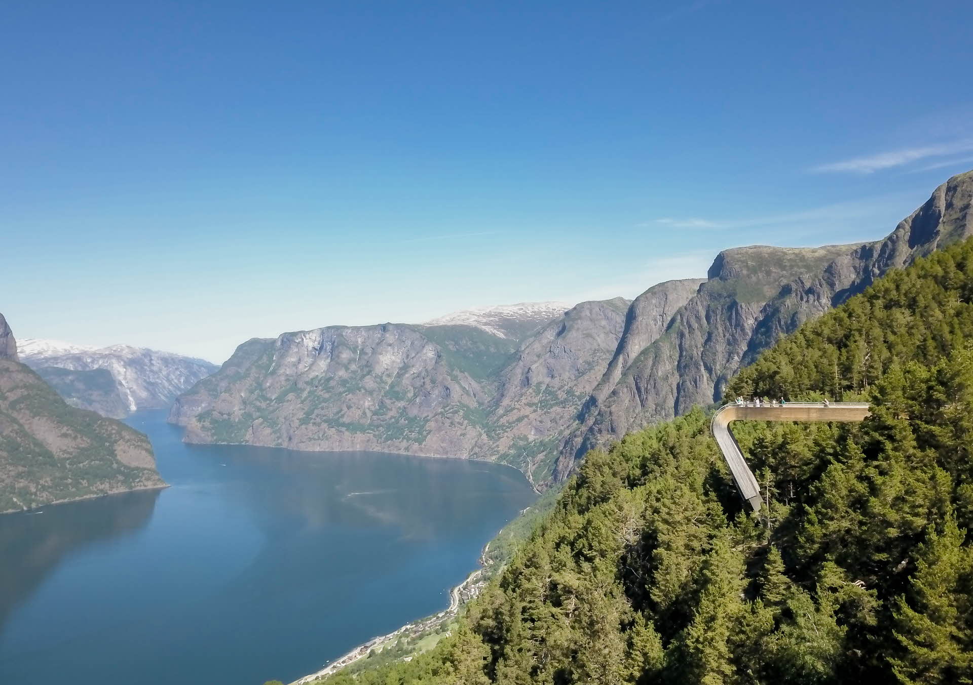 Overview picture towards Stegastein Viewpoint in summer. Green forest, steep mountain sides and the Aurlandsfjord